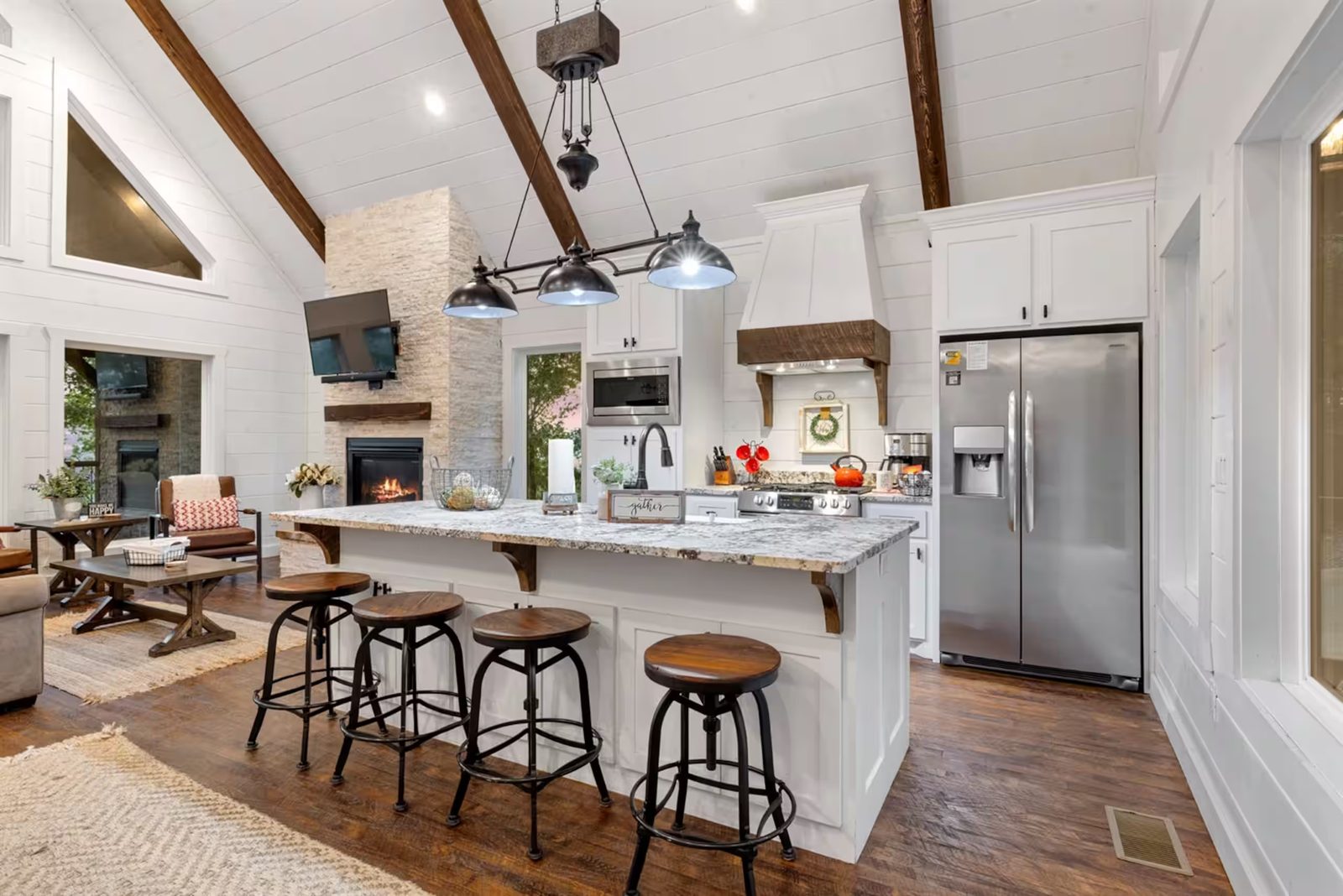 Kitchen island with seating, and the fireplace beyond.